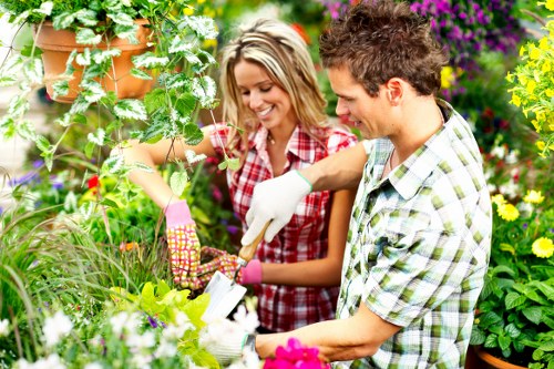 Risk assessment form on clipboard alongside gardening tools